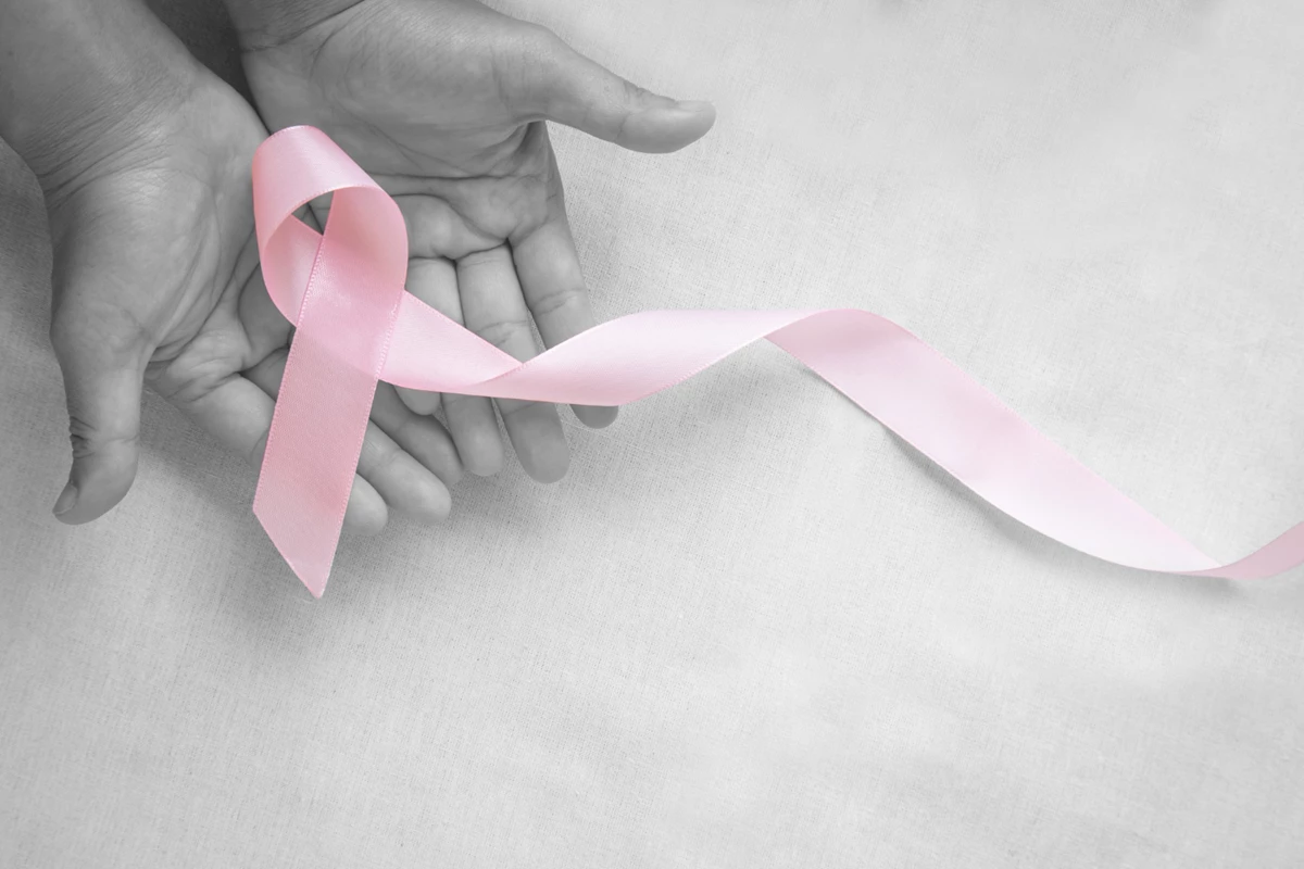 Hands Holding Pink Ribbon Curl White Isolated Fabric With Copy Space Breast Cancer Awareness Male Breast Cancer Disease World Cancer Day Healthcare Hospital Insurance Concept (1)